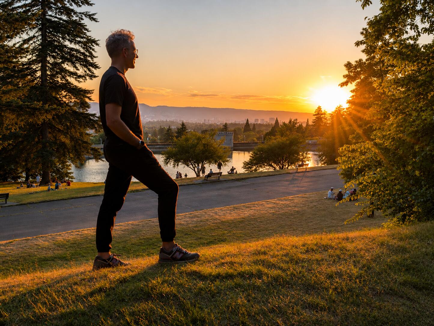 Brian standing on Mt. Tabor at golden hour, looking out toward the horizon