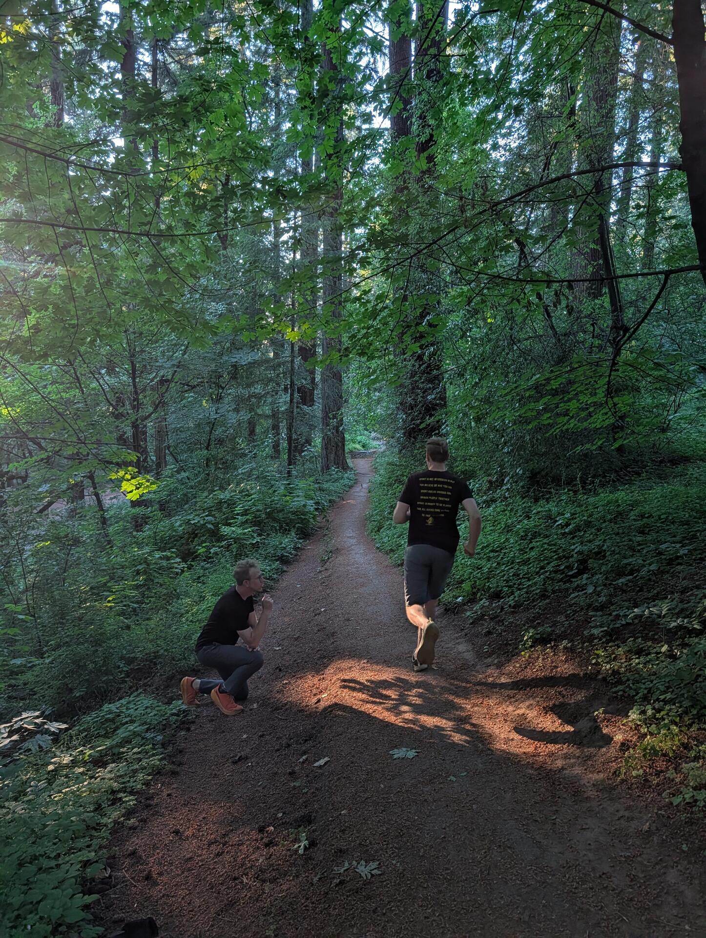 Brian crouched on the trail, watching a runner's gait on real terrain