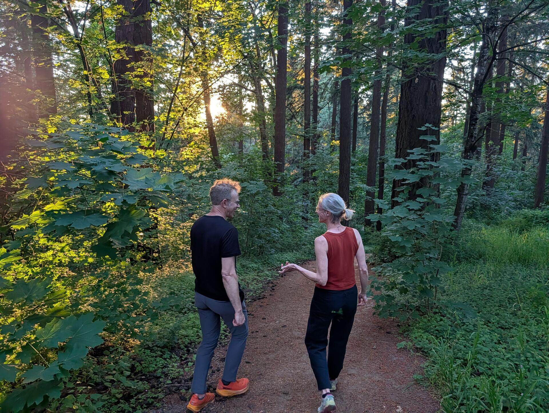 Brian and a client walking and talking on a golden trail at Mt. Tabor
